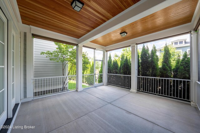 unfurnished sunroom with wood ceiling