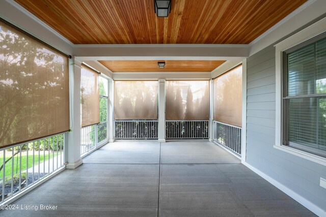 unfurnished sunroom with wooden ceiling