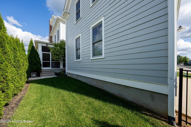 view of side of property with a yard