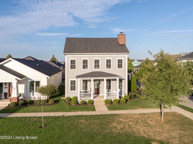 view of front of house featuring a front lawn and covered porch