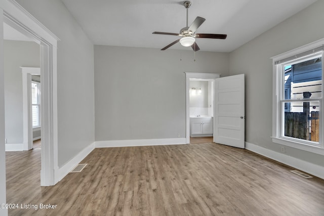 spare room featuring light hardwood / wood-style floors, ceiling fan, and plenty of natural light