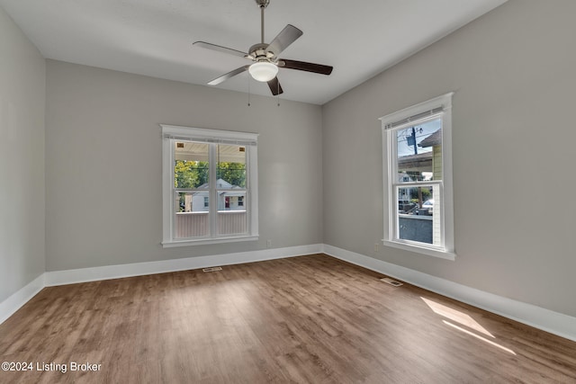 spare room featuring hardwood / wood-style floors and ceiling fan