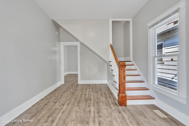 stairs featuring wood-type flooring