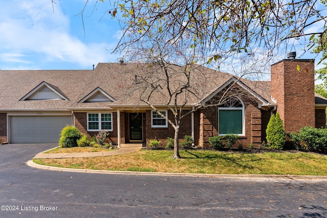 view of front facade with a front yard and a garage