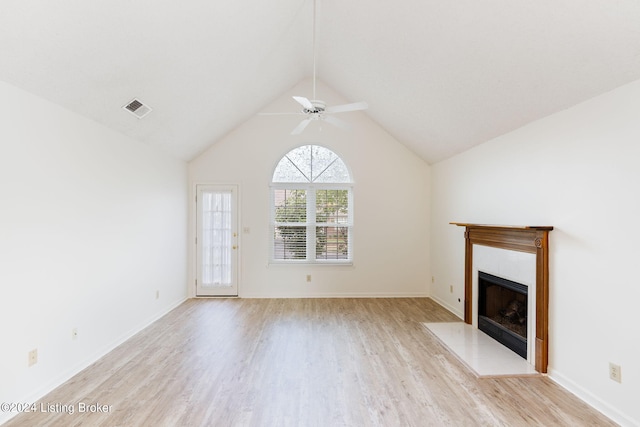 unfurnished living room featuring light wood-type flooring, vaulted ceiling, and ceiling fan