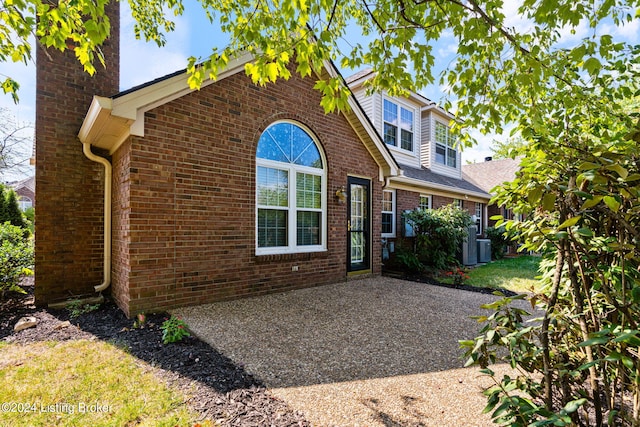 rear view of property with a patio and central air condition unit