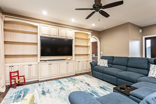 living room featuring hardwood / wood-style floors and ceiling fan