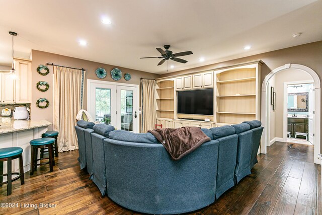 living room featuring dark hardwood / wood-style floors, ceiling fan, and french doors