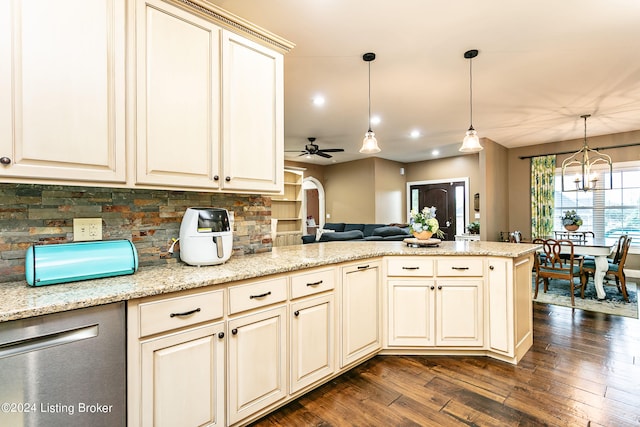 kitchen with pendant lighting, kitchen peninsula, cream cabinetry, ceiling fan with notable chandelier, and dark hardwood / wood-style flooring