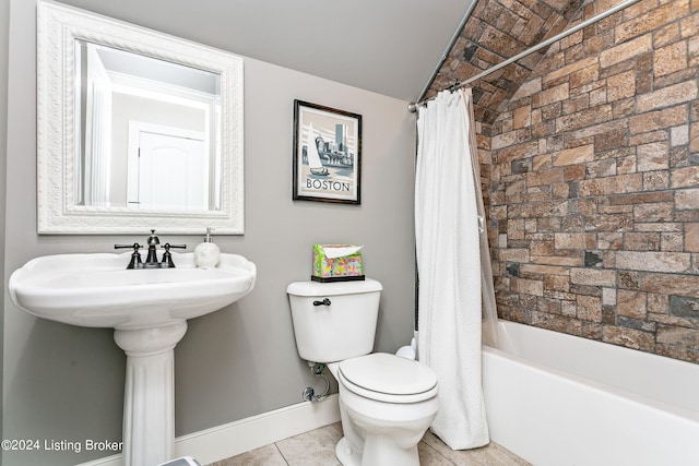 bathroom featuring shower / bathtub combination with curtain, vaulted ceiling, tile patterned flooring, and toilet