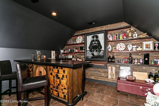 bar with lofted ceiling