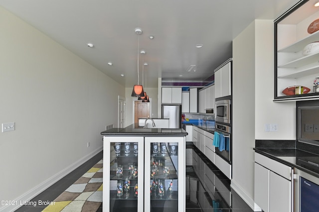 kitchen featuring wine cooler, white cabinetry, stainless steel appliances, and dark countertops