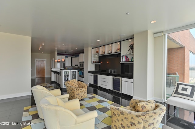 living area with beverage cooler, baseboards, and recessed lighting