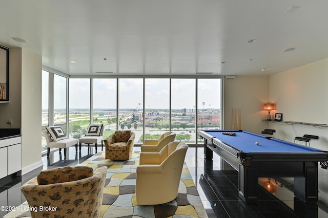 recreation room with expansive windows, a wealth of natural light, a city view, and billiards