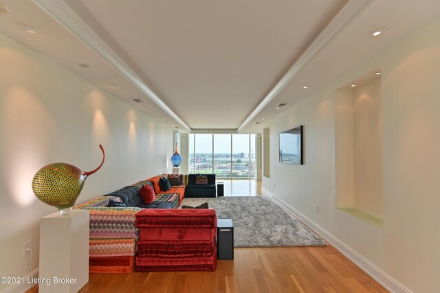 living room featuring floor to ceiling windows and hardwood / wood-style floors