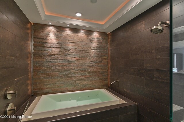 bathroom with a tray ceiling and plus walk in shower