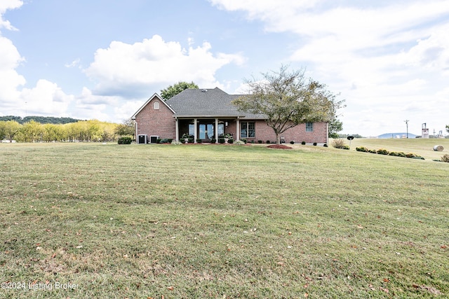 view of front of property featuring a front yard and a rural view