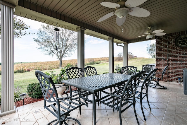 view of patio / terrace with ceiling fan and a rural view