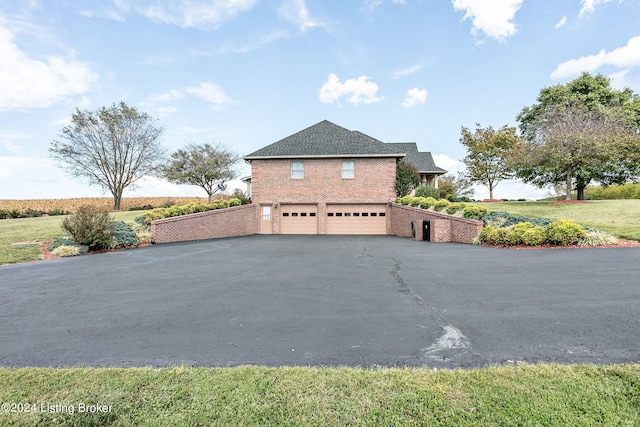 view of side of property with a garage and a yard