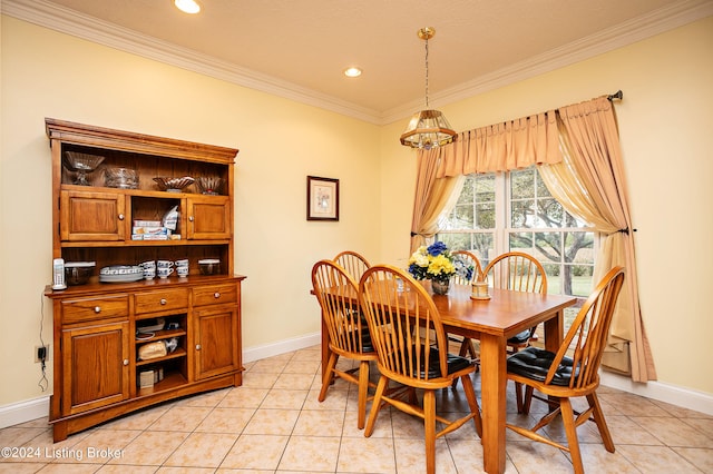 dining area with a notable chandelier, light tile patterned flooring, ornamental molding, and a textured ceiling