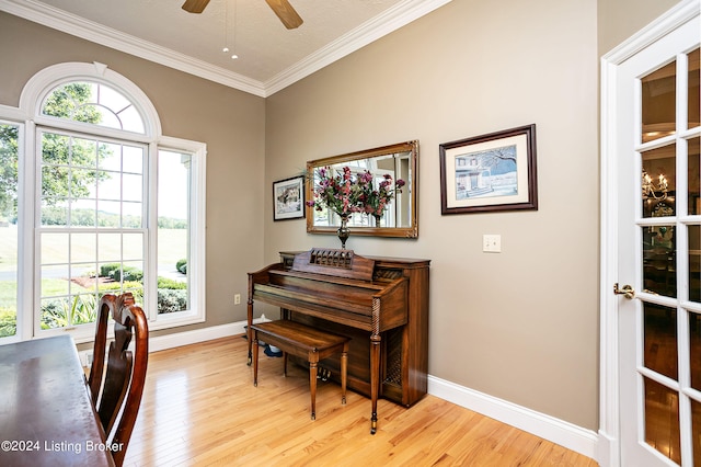 miscellaneous room with a textured ceiling, ornamental molding, ceiling fan, and light hardwood / wood-style flooring