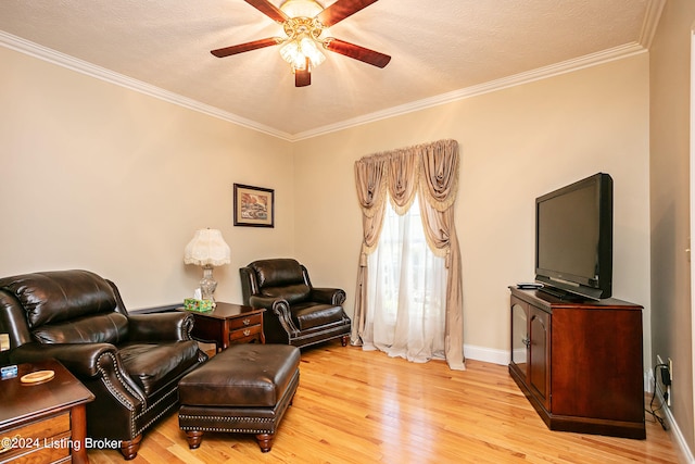 living room featuring ceiling fan, a textured ceiling, crown molding, and light hardwood / wood-style floors