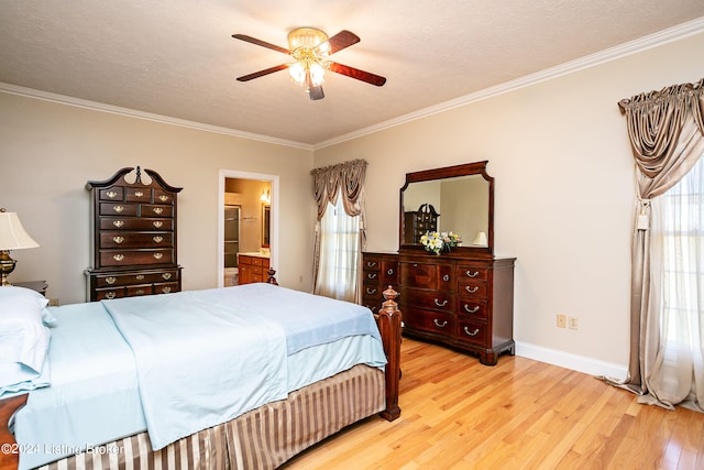 bedroom featuring ceiling fan, a textured ceiling, light hardwood / wood-style flooring, and connected bathroom