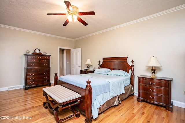 bedroom with ceiling fan, a textured ceiling, light hardwood / wood-style flooring, and ornamental molding