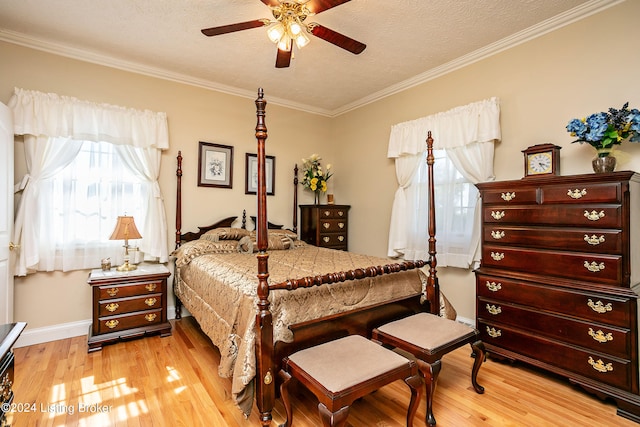 bedroom with ornamental molding, light wood-type flooring, ceiling fan, and a textured ceiling