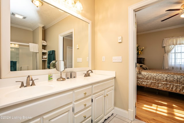 bathroom featuring vanity, a textured ceiling, crown molding, ceiling fan, and hardwood / wood-style flooring