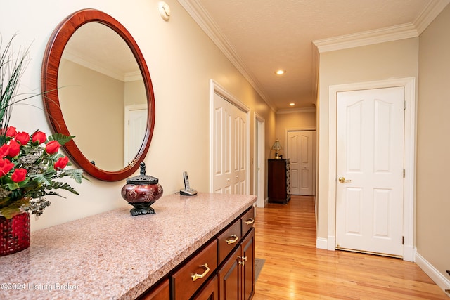 bathroom featuring ornamental molding and hardwood / wood-style floors