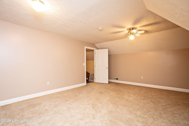 bonus room with ceiling fan, a textured ceiling, carpet floors, and vaulted ceiling