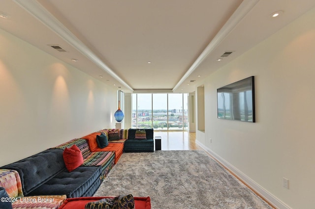 living room featuring expansive windows, carpet floors, and crown molding