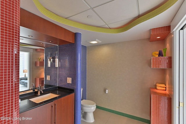222 E Witherspoon St Unit 703-704, Louisville, KY 40202 - bathroom with toilet, tile patterned floors, vanity, a tray ceiling, and a paneled ceiling