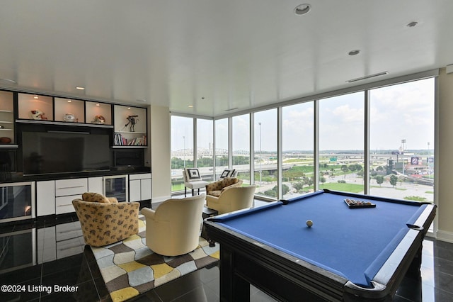 rec room with expansive windows, beverage cooler, billiards, and dark tile patterned floors