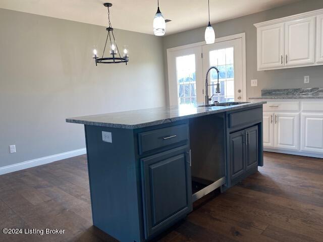 kitchen with white cabinetry, a center island with sink, and dark hardwood / wood-style flooring