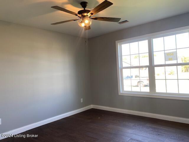 unfurnished room featuring dark hardwood / wood-style flooring and ceiling fan