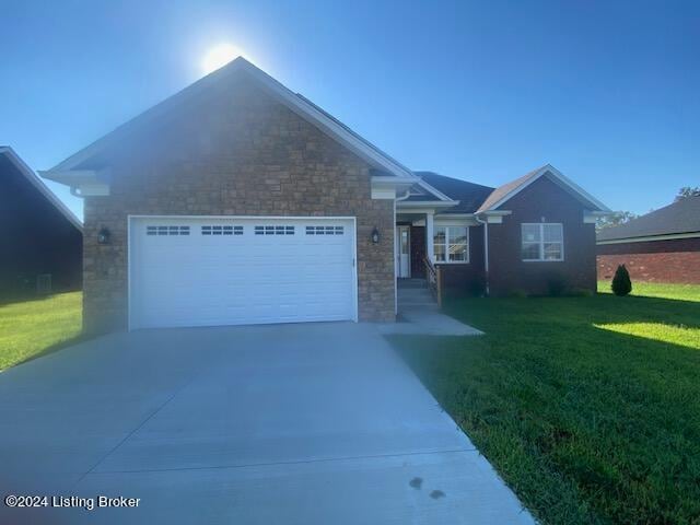 view of front of home with a garage and a front lawn