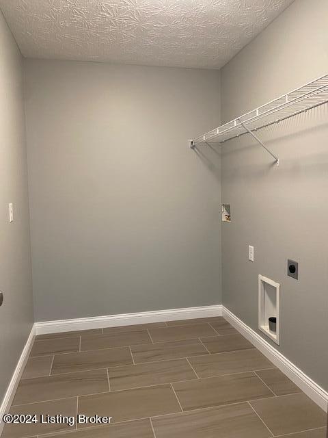 laundry room featuring a textured ceiling, hookup for an electric dryer, and washer hookup