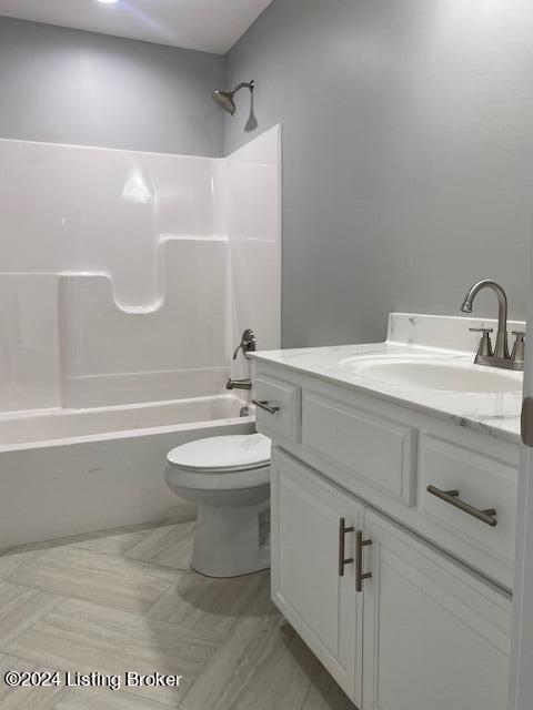 full bathroom with bathtub / shower combination, vanity, and toilet