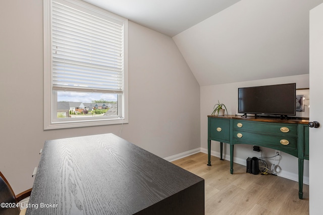 bedroom featuring lofted ceiling and light hardwood / wood-style floors