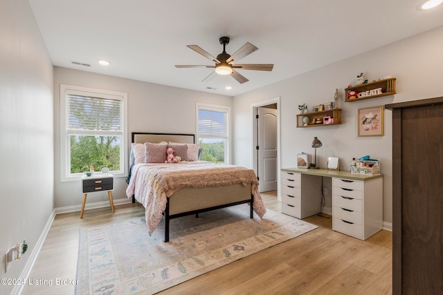 bedroom with light wood-type flooring, multiple windows, and ceiling fan