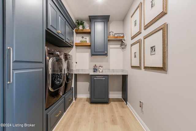 clothes washing area featuring light wood-type flooring, independent washer and dryer, and cabinets