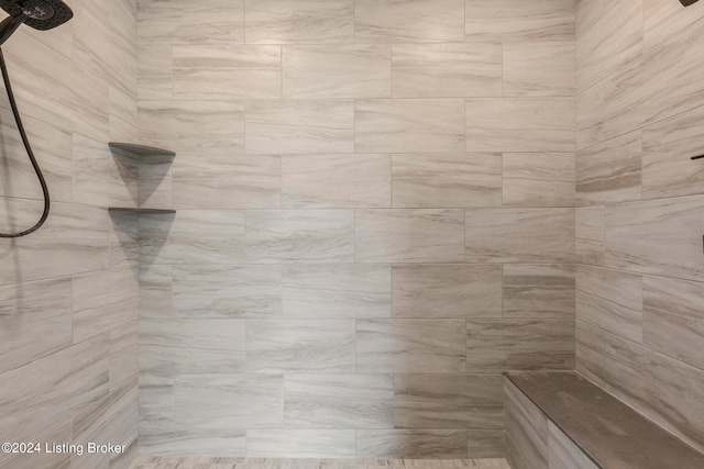 bathroom with a tile shower