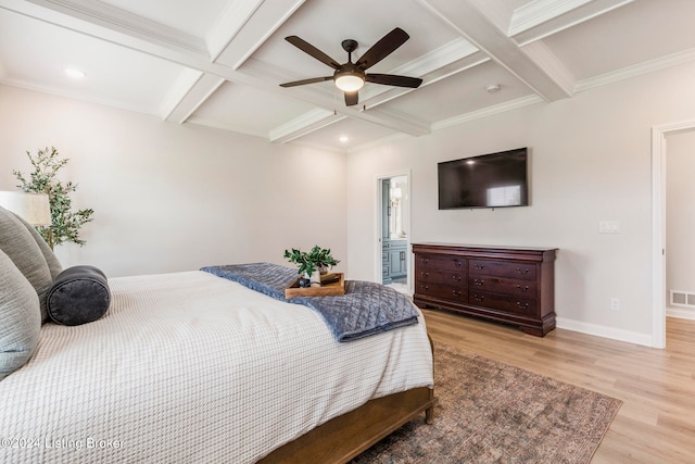 bedroom featuring ceiling fan, beamed ceiling, coffered ceiling, ensuite bath, and light hardwood / wood-style floors