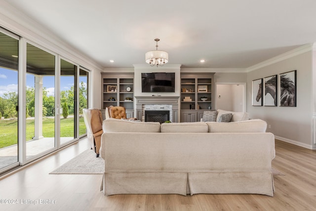 living room featuring crown molding, light hardwood / wood-style floors, and an inviting chandelier