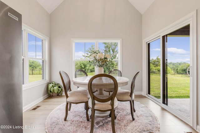 dining space with light hardwood / wood-style floors and plenty of natural light