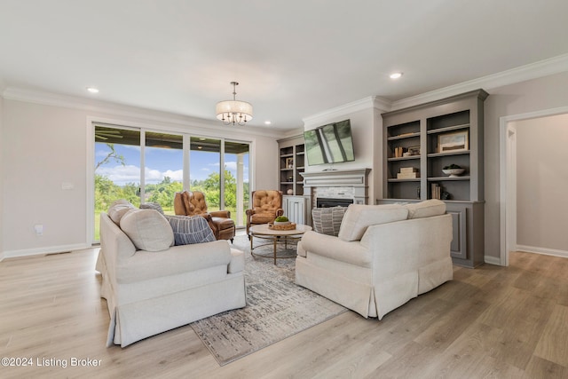 living room featuring a notable chandelier, light wood-type flooring, and ornamental molding