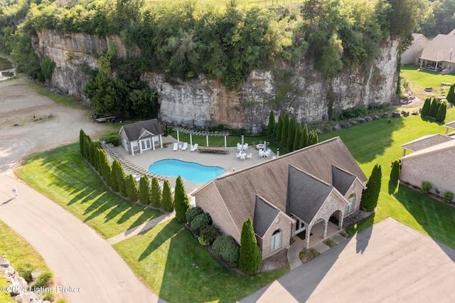 view of pool with a patio and a yard