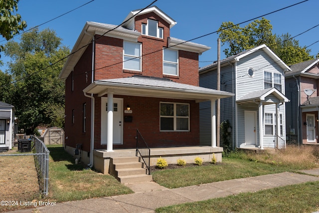 front of property featuring a shed and a front yard